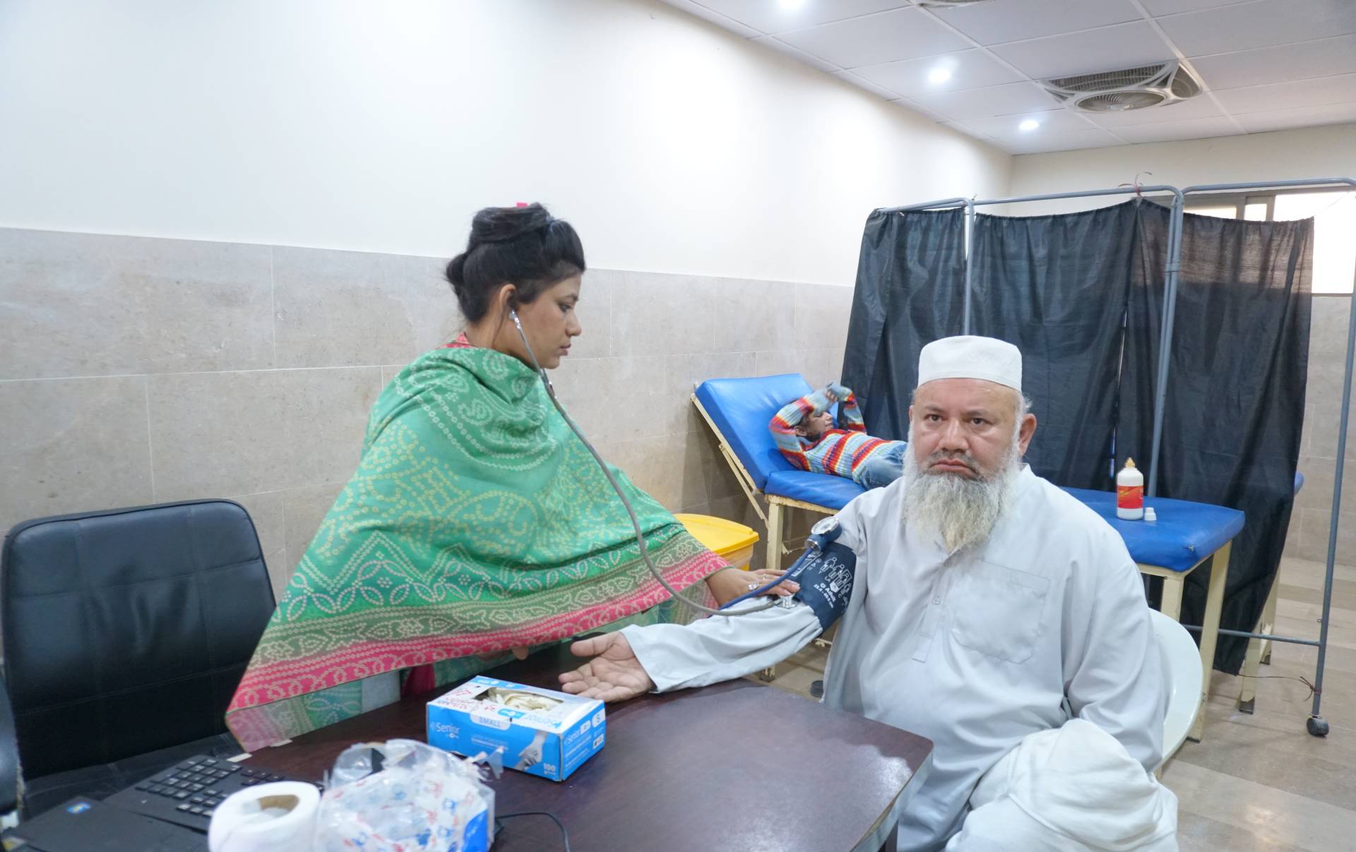 Al Mustafa Trust volunteer sorting and preparing donated clothes to distribute among underprivileged families